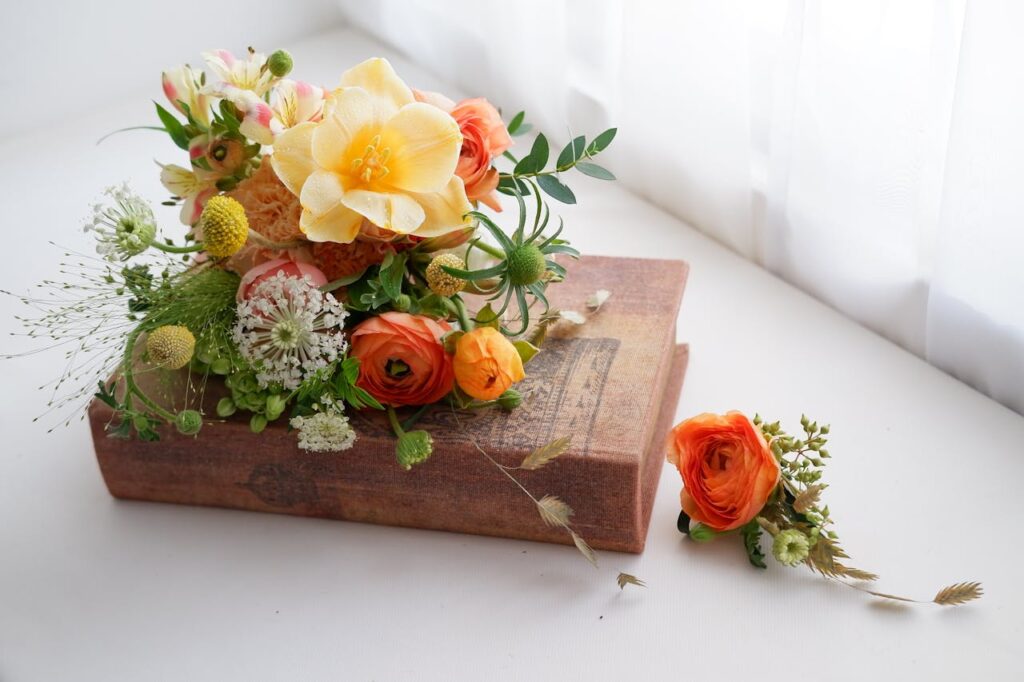 pexels-photo-30436803 Beautiful floral arrangement atop a vintage book, capturing a serene and elegant aesthetic.